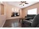 Inviting living room features neutral walls, modern ceiling fan and comfortable seating perfect for relaxation at 5835 Running Horse Dr, North Las Vegas, NV 89081