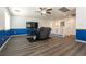 Spacious living room featuring wood floors, chair, and blue and white accent walls at 5835 Running Horse Dr, North Las Vegas, NV 89081