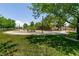 Scenic view of a neighborhood park with walking paths, lush trees, and green grass at 5835 Running Horse Dr, North Las Vegas, NV 89081