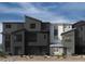 Modern three-story townhome showcasing a sleek architectural design and neutral color palette at 5870 Kips Bay St, Las Vegas, NV 89148