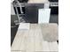 Selection of modern finishes with wood-look flooring, granite countertop, and carpet samples at 5870 Kips Bay St, Las Vegas, NV 89148