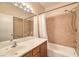 A bathroom featuring a sink, mirror, vanity, tile flooring, tub, and a shower at 5950 Barbosa Dr # 8, North Las Vegas, NV 89031