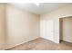 A neutral bedroom features carpet, base molding, and a double door closet at 5950 Barbosa Dr # 8, North Las Vegas, NV 89031