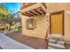 Exterior condo entryway with a painted door, shutters, and small decorative window at 5950 Barbosa Dr # 8, North Las Vegas, NV 89031