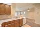 Open kitchen featuring oak cabinets, white countertops and appliances, and tiled flooring at 5950 Barbosa Dr # 8, North Las Vegas, NV 89031