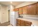 Bright kitchen features light countertops, wooden cabinets, and essential appliances at 5950 Barbosa Dr # 8, North Las Vegas, NV 89031