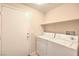 A laundry room featuring a shelf, washer, dryer, and tile flooring at 5950 Barbosa Dr # 8, North Las Vegas, NV 89031