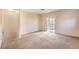 Spacious living room with neutral carpet, light walls, and a sliding door to the balcony at 5950 Barbosa Dr # 8, North Las Vegas, NV 89031