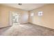 Bright living room featuring neutral carpet, light walls, and a sliding door to the balcony at 5950 Barbosa Dr # 8, North Las Vegas, NV 89031