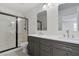 Bathroom with double vanity, countertop, walk-in shower, and modern fixtures at 6019 Sonoma Station Ave, Las Vegas, NV 89139