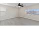 Bright bedroom with neutral colors, ceiling fan, and large windows at 6019 Sonoma Station Ave, Las Vegas, NV 89139