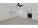 Bright bedroom featuring a ceiling fan, wood-look floors, and a large window with neighborhood views at 6019 Sonoma Station Ave, Las Vegas, NV 89139