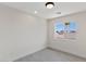 Bedroom with a ceiling light, wood-look floors, and a window offering outdoor views at 6019 Sonoma Station Ave, Las Vegas, NV 89139