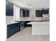 Modern kitchen featuring dark blue cabinets, stainless steel appliances, and a bright quartz countertop island at 6019 Sonoma Station Ave, Las Vegas, NV 89139