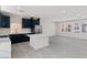 Modern kitchen with navy blue cabinets, quartz countertops, and a large island perfect for entertaining and cooking at 6019 Sonoma Station Ave, Las Vegas, NV 89139