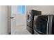 Convenient laundry room equipped with front loading washer and dryer units at 6019 Sonoma Station Ave, Las Vegas, NV 89139