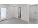 Clean and bright living area showcasing the tile flooring, a door to the backyard, and laundry access at 6019 Sonoma Station Ave, Las Vegas, NV 89139