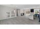 Open concept living area with modern finishes, light wood floors, and plenty of natural light from large windows at 6019 Sonoma Station Ave, Las Vegas, NV 89139