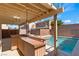 Backyard featuring a covered bar area overlooking the sparkling pool and private block wall fence at 6019 Sonoma Station Ave, Las Vegas, NV 89139