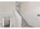 Well-lit staircase with wooden treads and white banister, featuring neutral décor at 6019 Sonoma Station Ave, Las Vegas, NV 89139