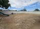 Wide shot of the backyard, enclosed by a white block wall, with a slide for outdoor recreation at 6500 Hill View Ave, Las Vegas, NV 89107