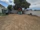 View of backyard featuring a tree, playset, grill and white block wall at 6500 Hill View Ave, Las Vegas, NV 89107