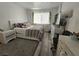 Bright bedroom featuring a bed, television, vanity, and light grey wood flooring at 6500 Hill View Ave, Las Vegas, NV 89107