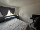 Bedroom featuring carpet flooring, a bed and a black computer chair at 6500 Hill View Ave, Las Vegas, NV 89107