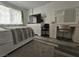 Bedroom featuring a bed, television, vanity, and light grey wood flooring at 6500 Hill View Ave, Las Vegas, NV 89107