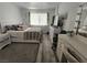Bright bedroom featuring a bed, television, vanity, and light grey wood flooring at 6500 Hill View Ave, Las Vegas, NV 89107