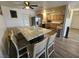 Open kitchen with granite island and wood-look flooring, perfect for gatherings at 6500 Hill View Ave, Las Vegas, NV 89107