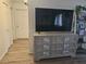 Cozy living room featuring a large flat-screen TV and stylish gray cabinet at 6500 Hill View Ave, Las Vegas, NV 89107