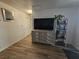 Comfortable living room with a large TV, stylish cabinet, and wood-look flooring at 6500 Hill View Ave, Las Vegas, NV 89107