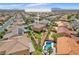 Beautiful aerial view of backyard oasis with swimming pool, lush landscaping, and mature trees at 6659 Alder Flower Ct, North Las Vegas, NV 89084