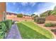 Beautiful backyard features a lush lawn, putting green and mature landscaping at 6659 Alder Flower Ct, North Las Vegas, NV 89084