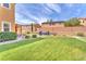 Spacious backyard with lush lawn, mature trees, seating area, and well-maintained landscaping at 6659 Alder Flower Ct, North Las Vegas, NV 89084