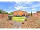 Expansive backyard featuring a lush lawn, putting green, and a seating area, perfect for outdoor enjoyment at 6659 Alder Flower Ct, North Las Vegas, NV 89084