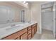 Bathroom featuring dual sinks, granite counters, and a separate toilet and shower area at 6659 Alder Flower Ct, North Las Vegas, NV 89084