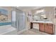 Bathroom featuring a glass-door shower, dual sinks, and ample vanity storage at 6659 Alder Flower Ct, North Las Vegas, NV 89084