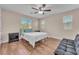 Bright bedroom with hardwood floors, a ceiling fan, and comfortable furniture at 6659 Alder Flower Ct, North Las Vegas, NV 89084