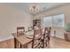 Formal dining room with wood floors, chandelier, and large windows at 6659 Alder Flower Ct, North Las Vegas, NV 89084