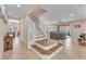 Welcoming entryway featuring a staircase with white railing, tile flooring, and natural light at 6659 Alder Flower Ct, North Las Vegas, NV 89084