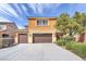 Two-story home with three-car garage, a tile roof, and manicured landscaping enhancing curb appeal at 6659 Alder Flower Ct, North Las Vegas, NV 89084