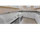 Well-equipped laundry room with white cabinets, gray countertops, stainless steel sink, and Maytag washer and dryer at 6659 Alder Flower Ct, North Las Vegas, NV 89084
