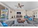Comfortable living room with a large sectional sofa, tile flooring, and access to the outdoor patio at 6659 Alder Flower Ct, North Las Vegas, NV 89084