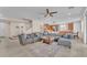 Open living space featuring a large sectional sofa, tile flooring, and seamless transition to the kitchen at 6659 Alder Flower Ct, North Las Vegas, NV 89084
