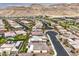 Scenic aerial view of a residential area with stylish homes, winding roads, and mountain backdrop at 6728 Regency Ridge Ct, Las Vegas, NV 89148