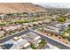 Wide aerial shot of a community with diverse homes, desert landscaping, and striking mountain views at 6728 Regency Ridge Ct, Las Vegas, NV 89148