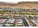 Expansive aerial view of a neighborhood featuring modern homes, streets, and mountain vistas at 6728 Regency Ridge Ct, Las Vegas, NV 89148