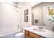 Bathroom features a tub and shower combination, vanity with wood cabinets and white countertop at 6728 Regency Ridge Ct, Las Vegas, NV 89148